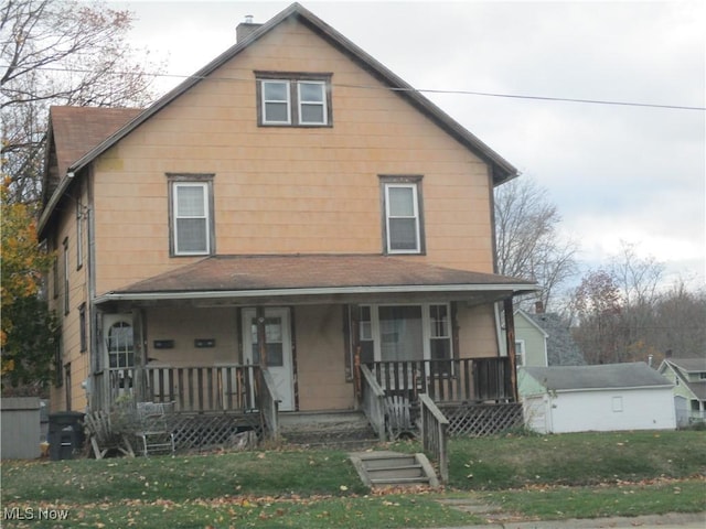 view of front of home with a front yard and a porch