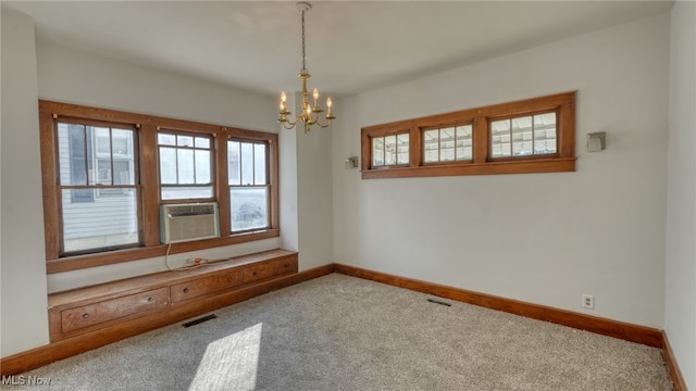 unfurnished room featuring carpet, a notable chandelier, and cooling unit