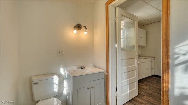 bathroom featuring vanity, hardwood / wood-style flooring, and toilet