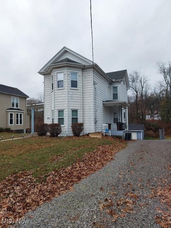 view of side of property with a lawn and central air condition unit