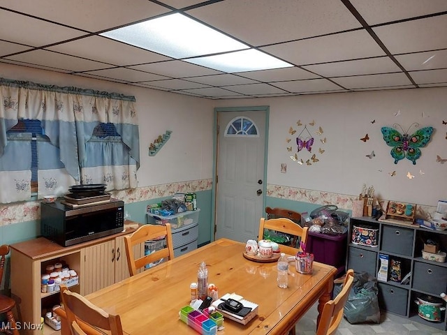 interior space with a paneled ceiling