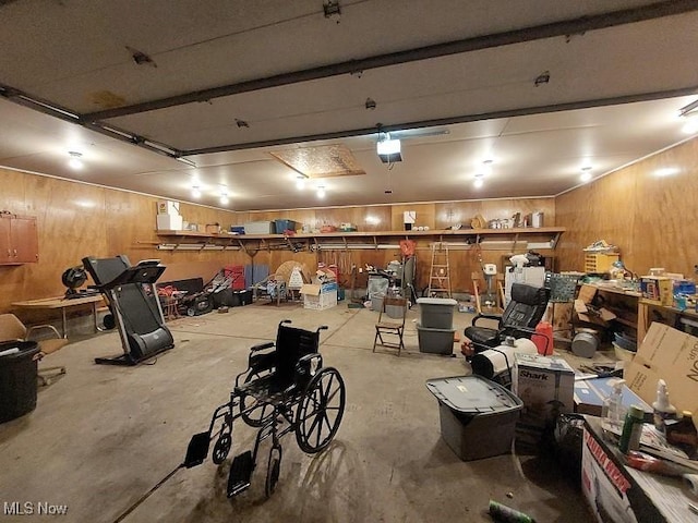 garage featuring a garage door opener and wood walls