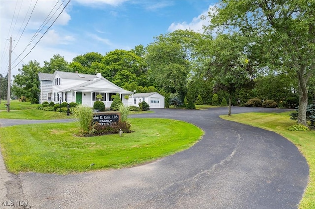 view of front of property with a front yard and a garage