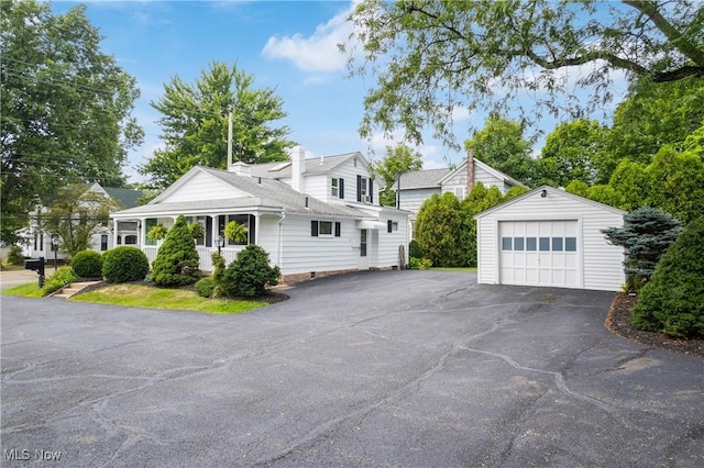 view of side of home featuring a garage and an outdoor structure