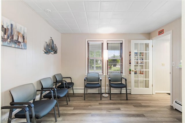 sitting room with a baseboard radiator and hardwood / wood-style flooring