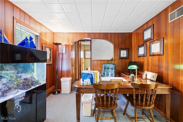 interior space with light carpet and wood walls