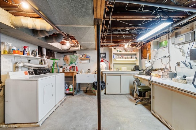 basement featuring washer and clothes dryer, a workshop area, and sink