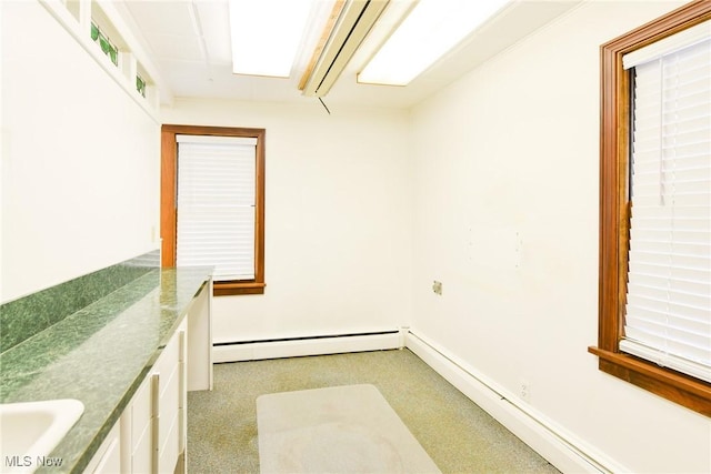 laundry room featuring sink and a baseboard radiator