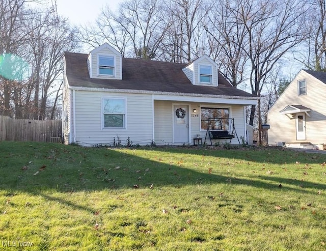 cape cod home featuring covered porch and a front yard