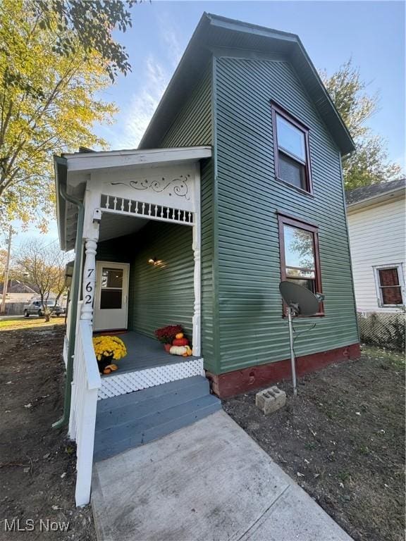 view of side of property with covered porch