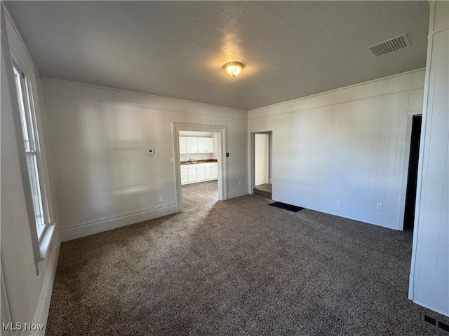 empty room featuring dark carpet