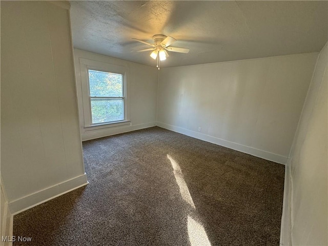 carpeted spare room with ceiling fan and a textured ceiling