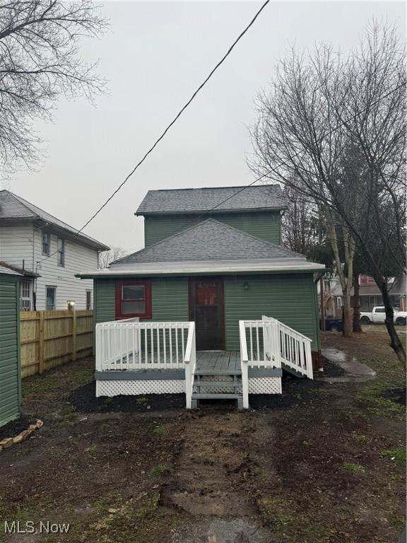 rear view of property featuring a wooden deck