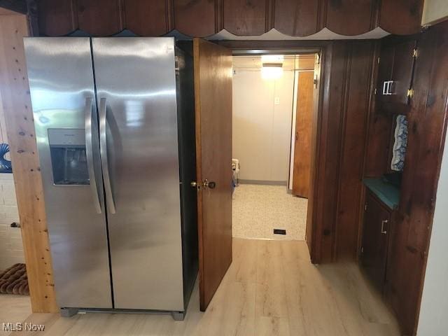 kitchen with stainless steel fridge with ice dispenser and light hardwood / wood-style floors