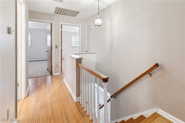 hallway featuring light hardwood / wood-style floors and a baseboard radiator