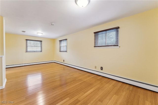 spare room with light hardwood / wood-style flooring and baseboard heating