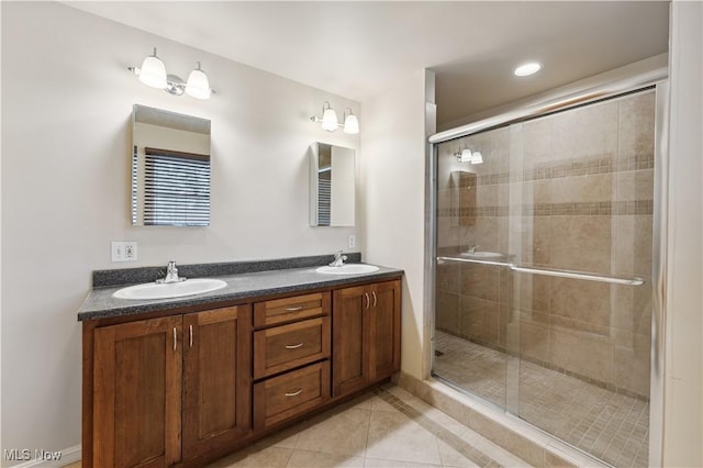 bathroom with tile patterned floors, vanity, and a shower with shower door