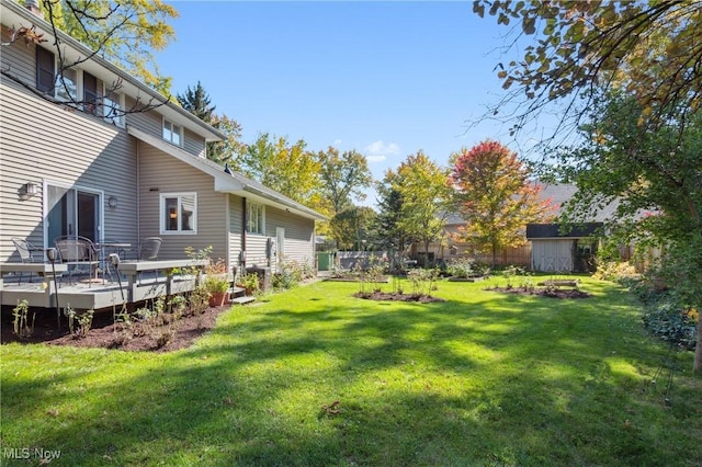 view of yard featuring a shed and a wooden deck