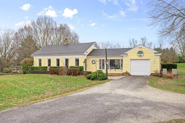 single story home featuring a front yard and a garage