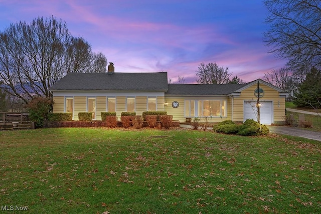 view of front of house with a lawn and a garage