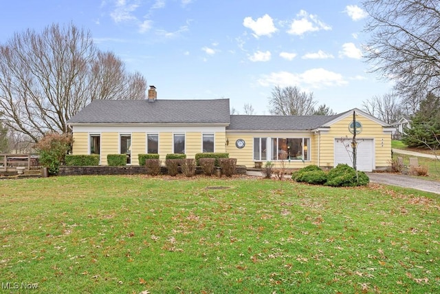 view of front of home with a garage and a front yard