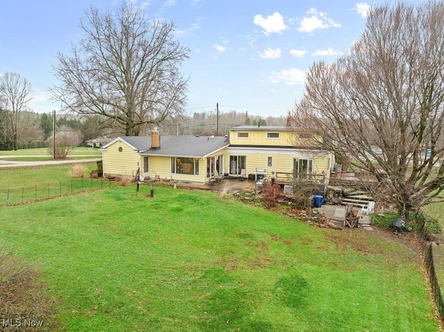 rear view of property with a yard and a patio