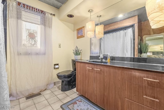 bathroom featuring tile patterned floors, vanity, and toilet