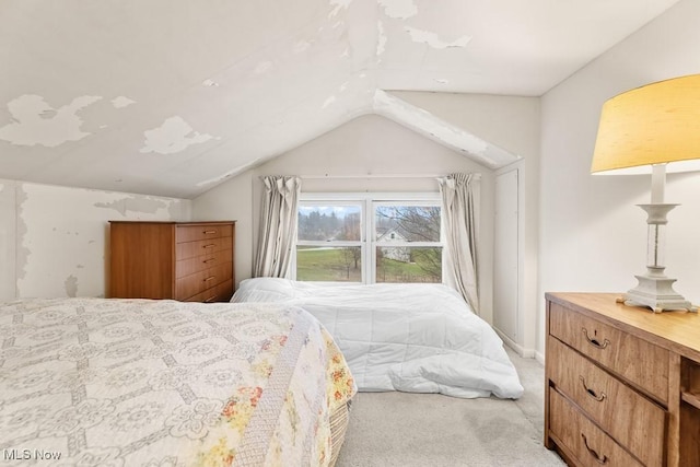 carpeted bedroom with lofted ceiling