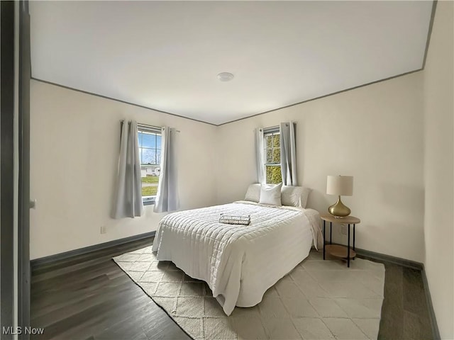 bedroom featuring wood-type flooring and multiple windows