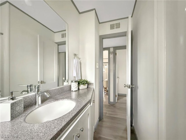 bathroom featuring hardwood / wood-style flooring and vanity