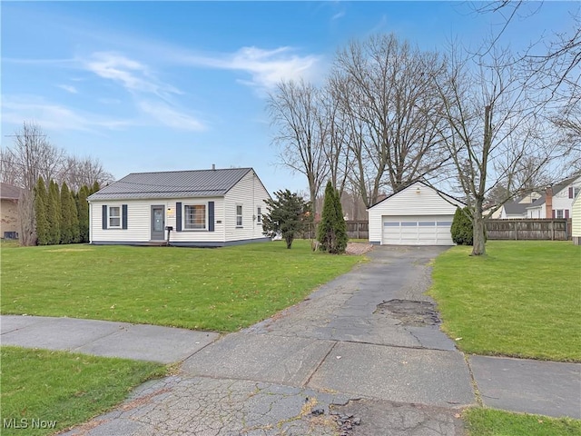 view of front of home with an outdoor structure, a front yard, and a garage