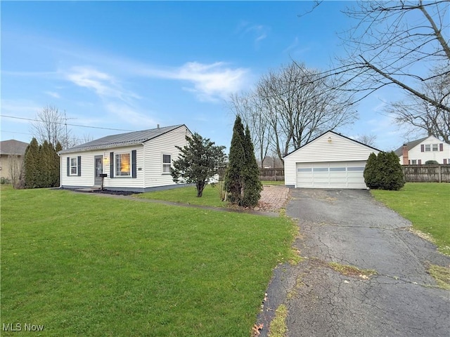 single story home featuring a garage, an outbuilding, and a front yard