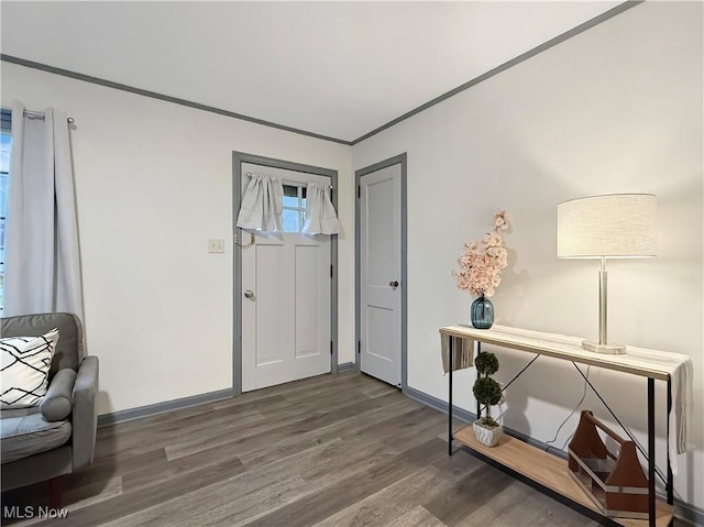 foyer entrance featuring ornamental molding and dark wood-type flooring