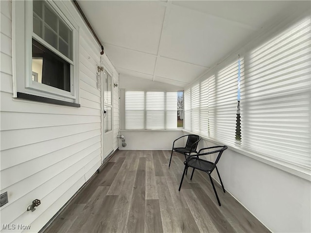 unfurnished sunroom featuring lofted ceiling