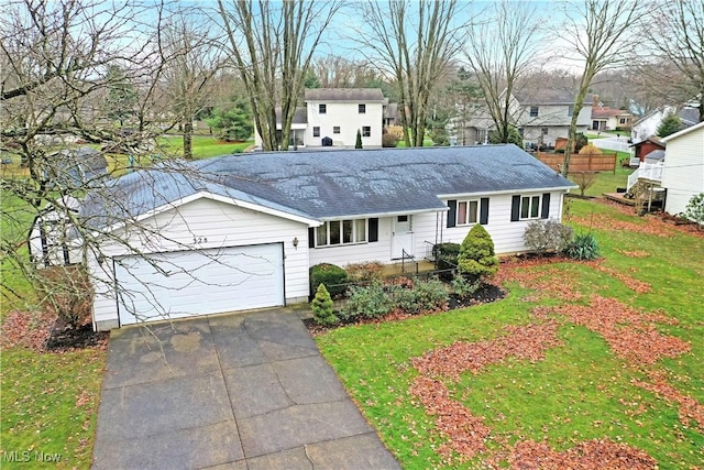 view of front facade featuring a garage and a front lawn