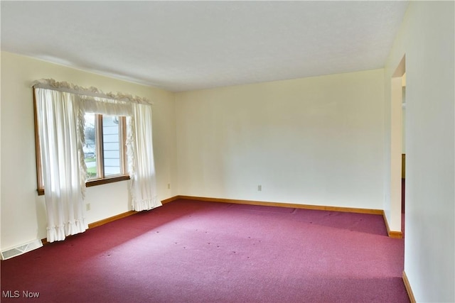 spare room featuring carpet