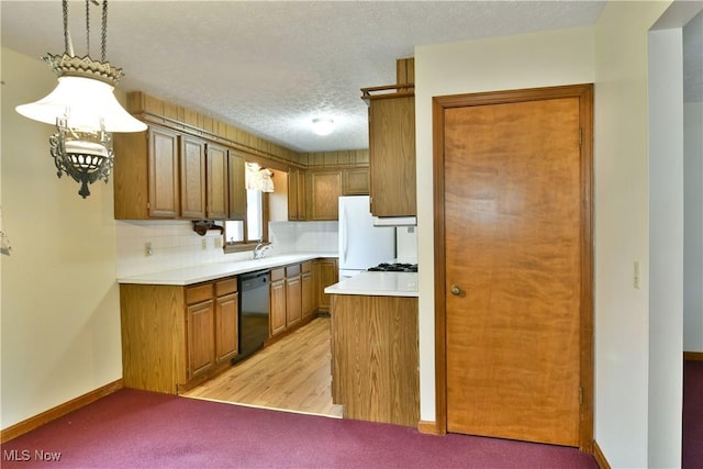 kitchen featuring sink, black dishwasher, light hardwood / wood-style floors, a textured ceiling, and decorative backsplash