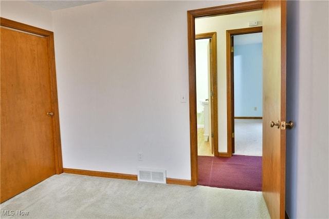 unfurnished room with light carpet