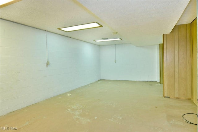 basement featuring a textured ceiling