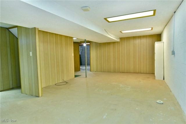 basement featuring wooden walls