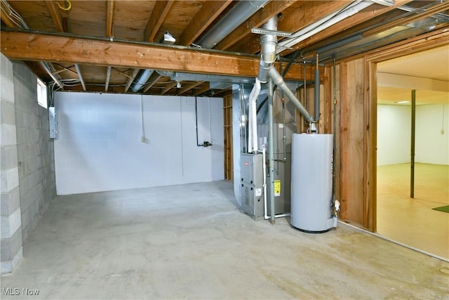 basement featuring electric panel, gas water heater, and heating unit