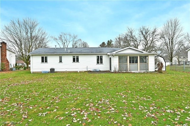 rear view of property with a lawn, a sunroom, and central air condition unit