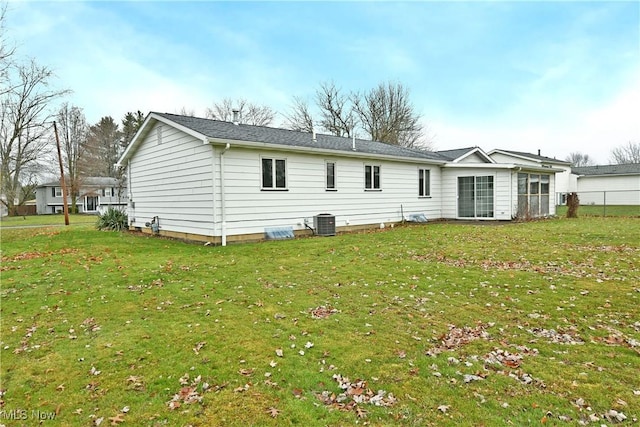 back of property with a lawn and cooling unit