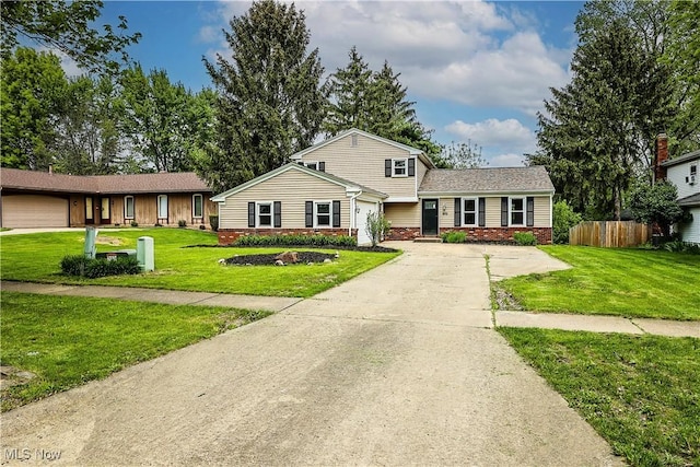 view of front of house with a front yard and a garage