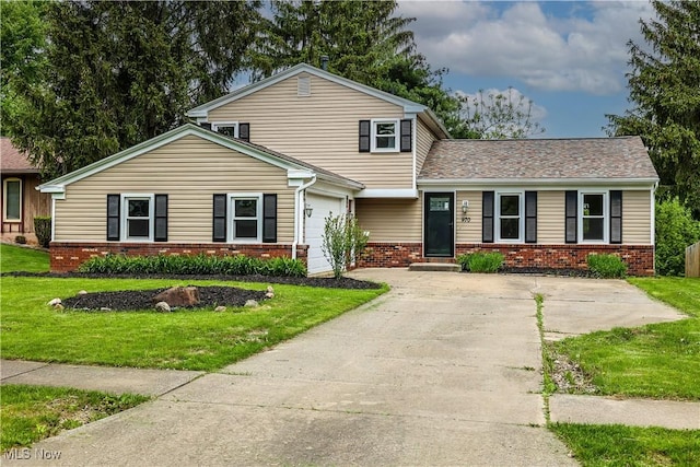 view of front facade with a garage and a front lawn