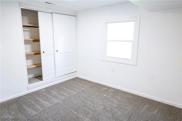 unfurnished bedroom with carpet floors and a closet