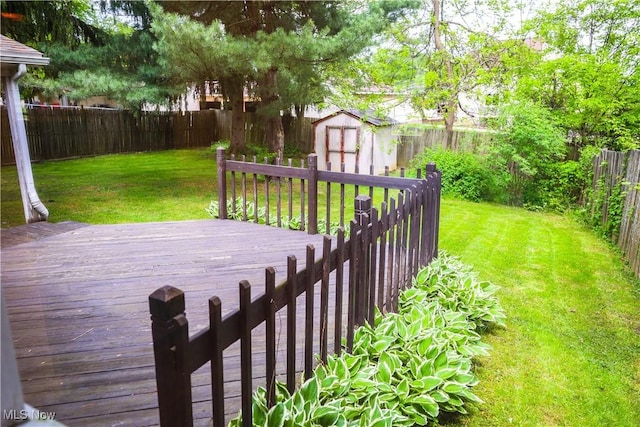 deck with a shed and a lawn