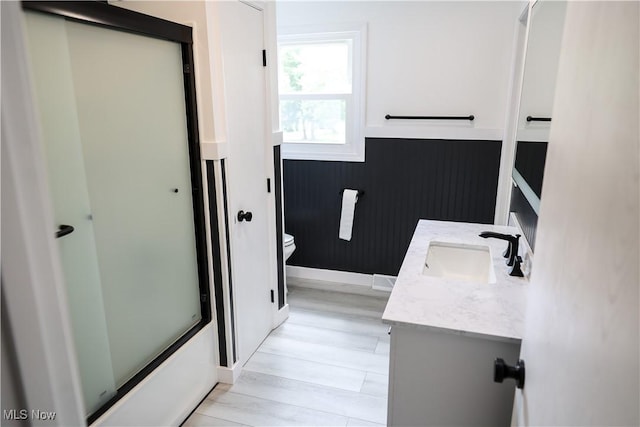 bathroom featuring hardwood / wood-style floors, vanity, and toilet