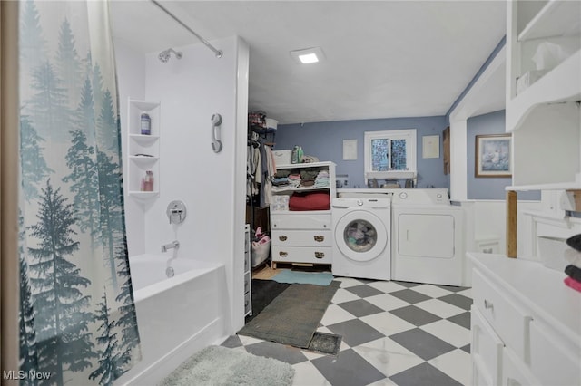 bathroom with washing machine and dryer and tub / shower combination