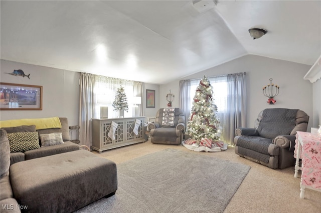 carpeted living room with plenty of natural light and lofted ceiling